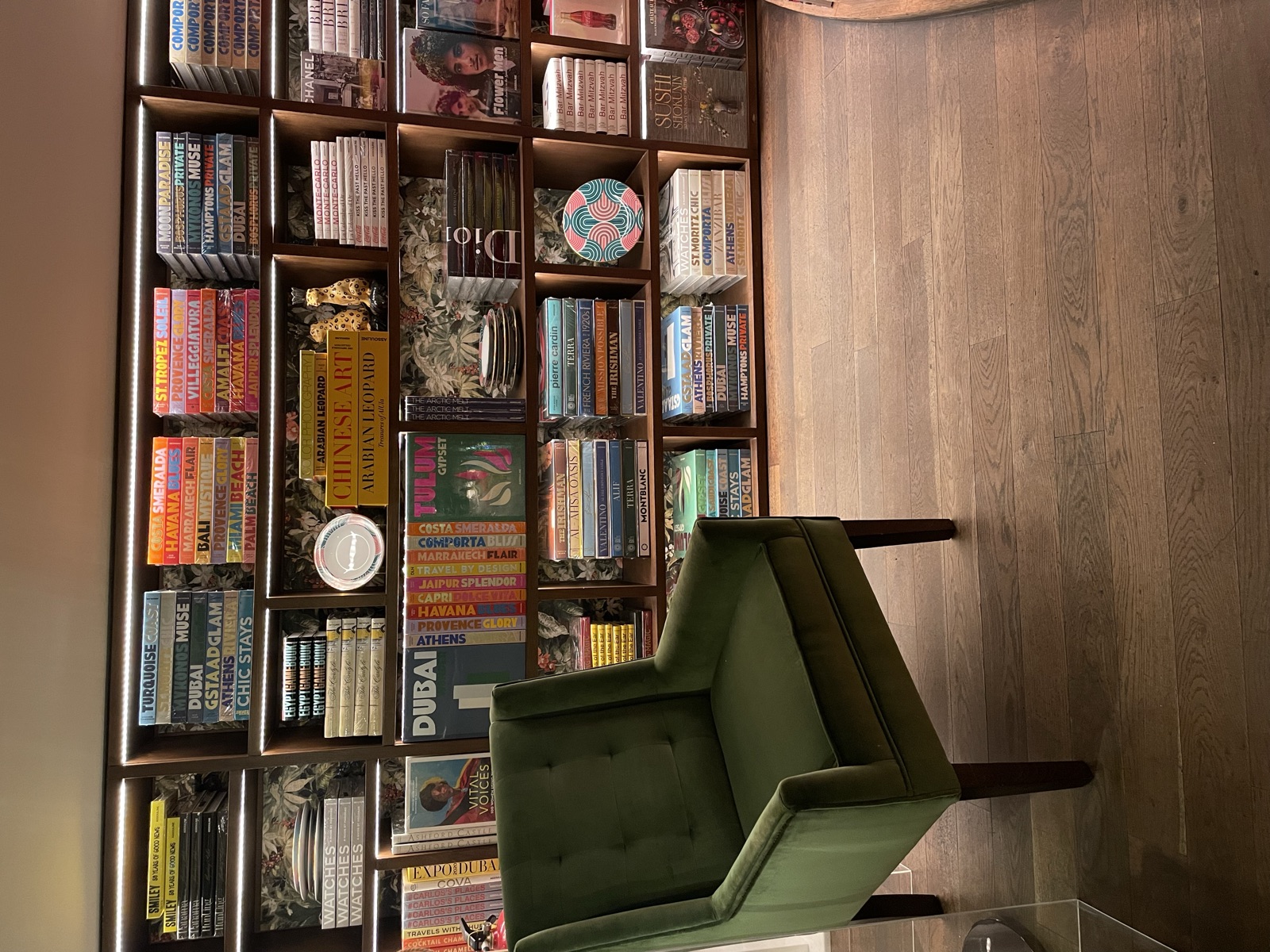 Bookshelf-lined room with a green armchair