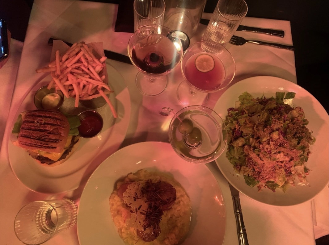 Table full of food and drinks shared with friends